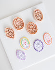 a collection of seven round cookie cutters with various designs, including a ghost, a pumpkin, and other Halloween-themed decorations.