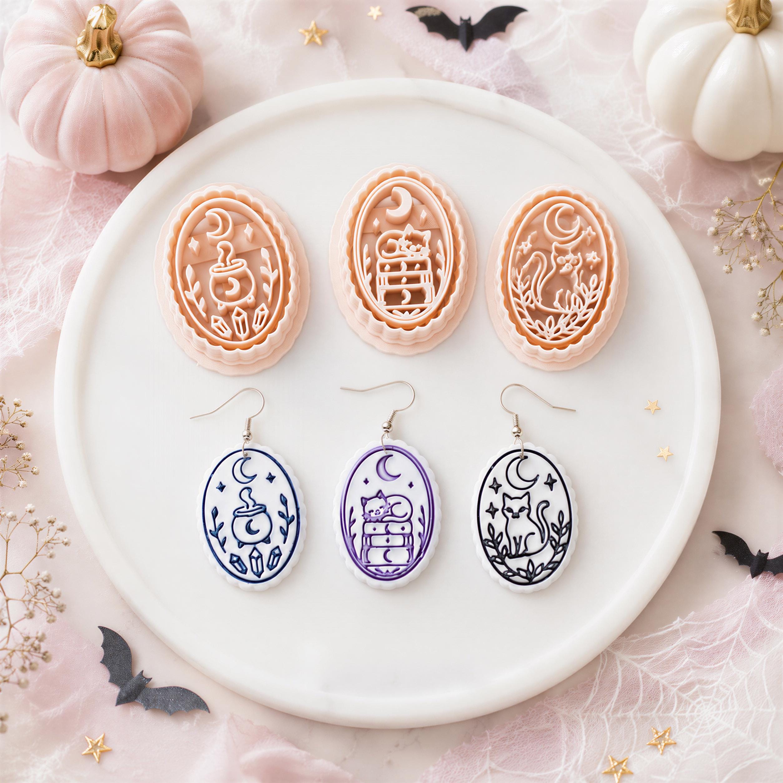 Pastel Halloween flat lay featuring clay cutters and matching earrings with moon, cauldron, cat and stacked books designs for clay earring makers.